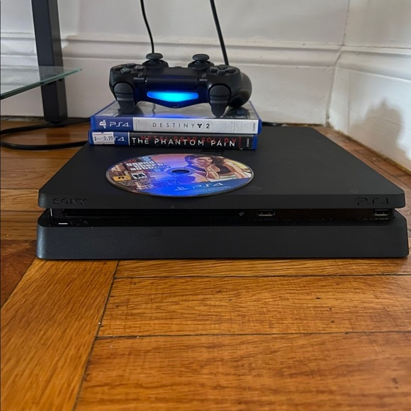 PS4 Slim 1TB With 6 Games And one Controller. Black color. Been used before. - Picture 1 of 4